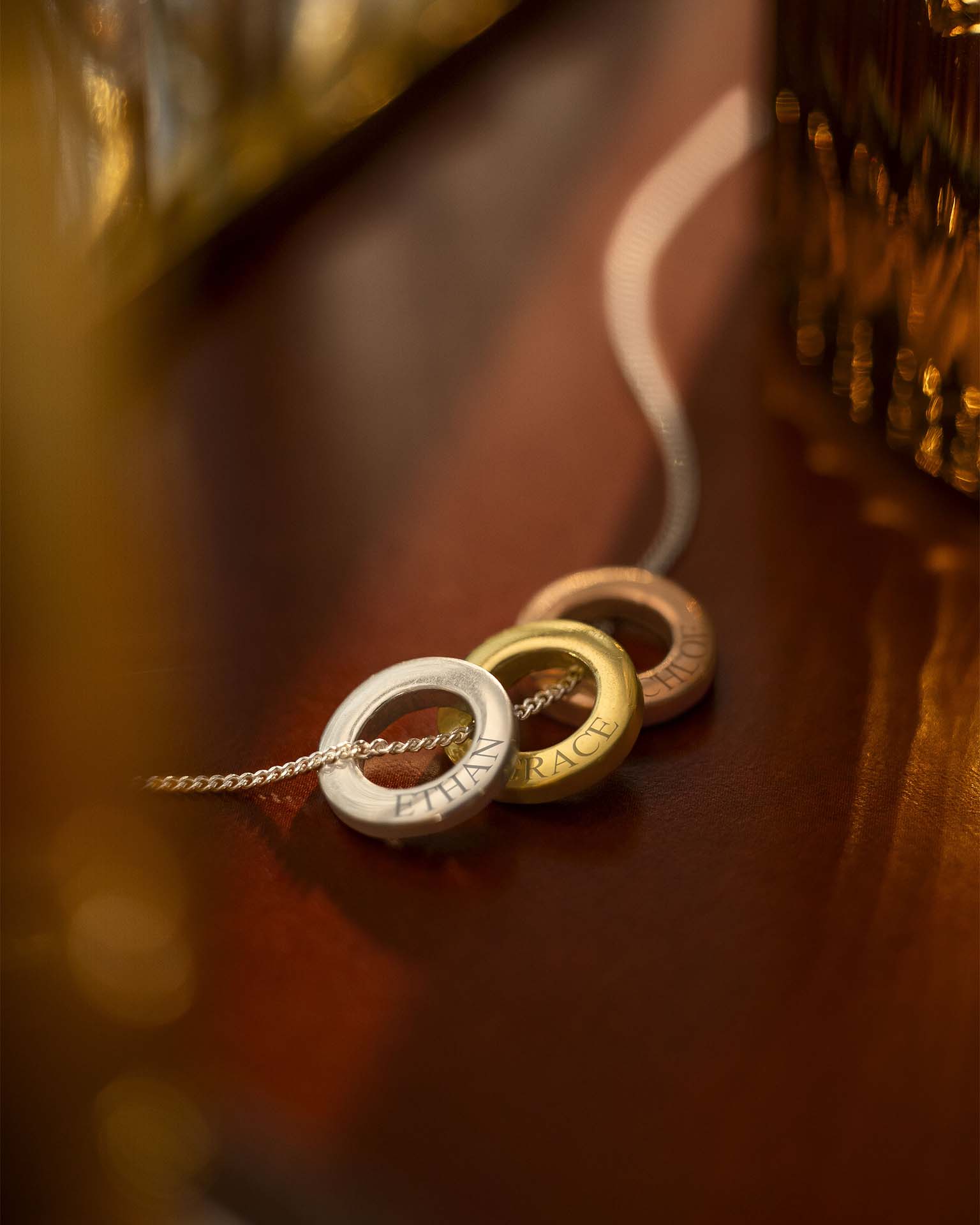 Three circular pendants on a chain against a blurred background | Christmas