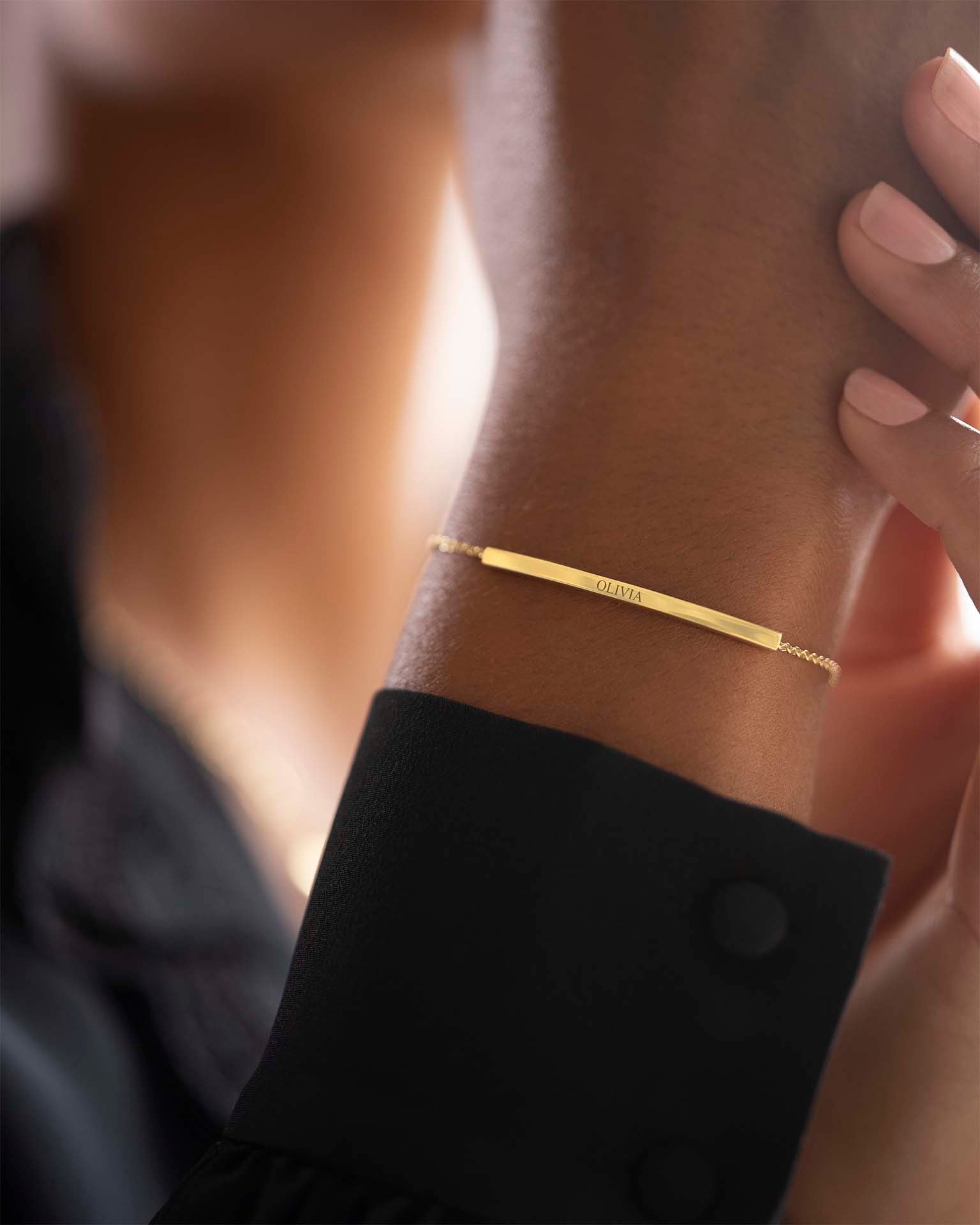 Gold bracelet on a wrist with a blurred background | Christmas