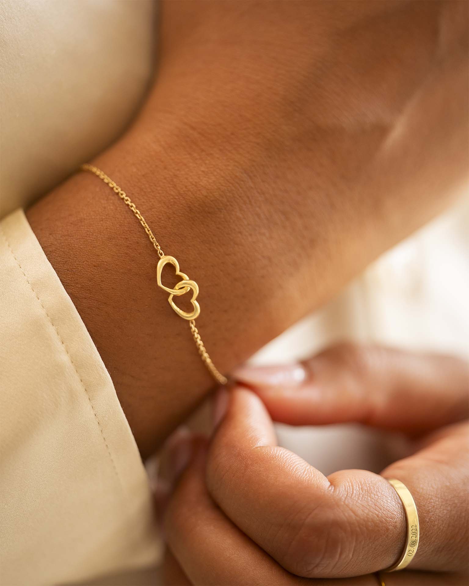 Gold bracelet with heart design on a wrist | Christmas