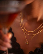 Close-up of a person wearing gold necklaces with a blurred background