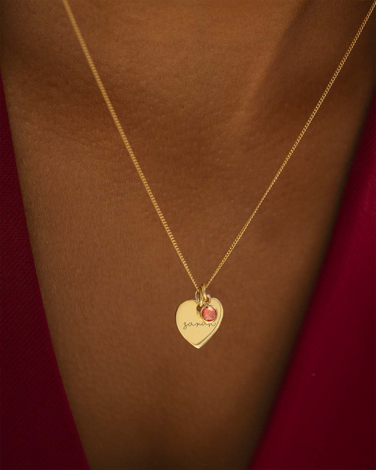 Gold necklace with a heart-shaped pendant on a brown background | Christmas