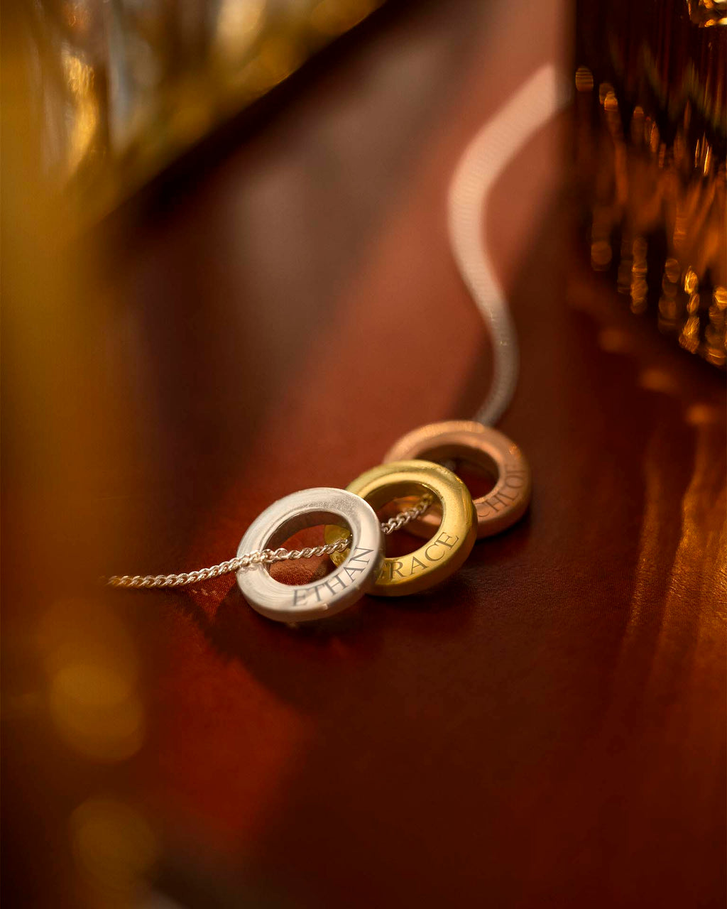 Three circular pendants on a chain against a blurred background | Christmas