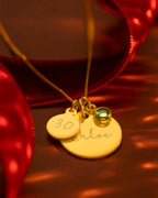 Gold necklace on red background with ribbon behind. | Christmas