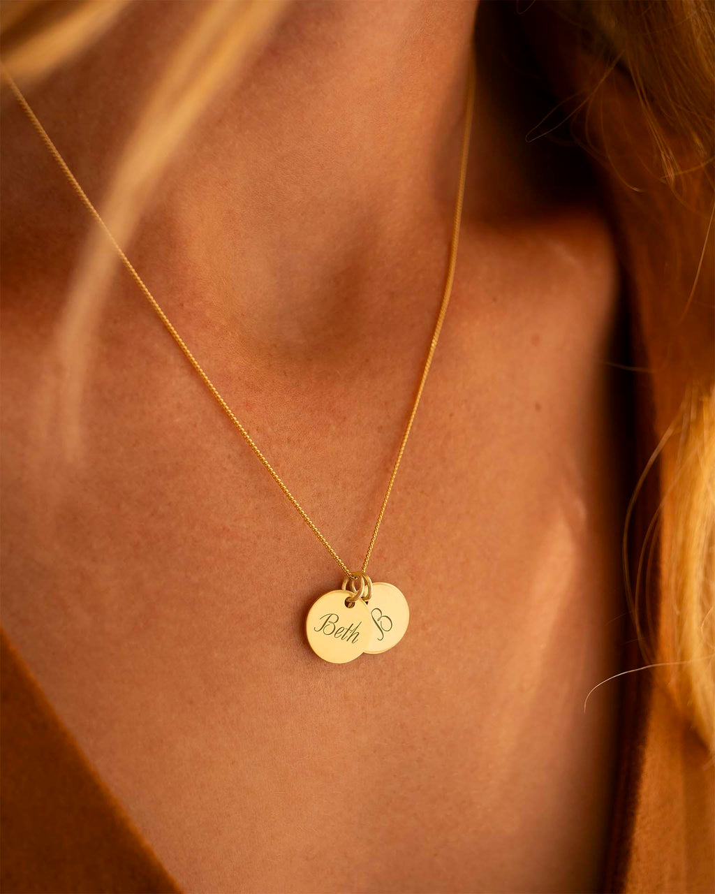 Gold necklace with a pendant on a person's neck | Christmas