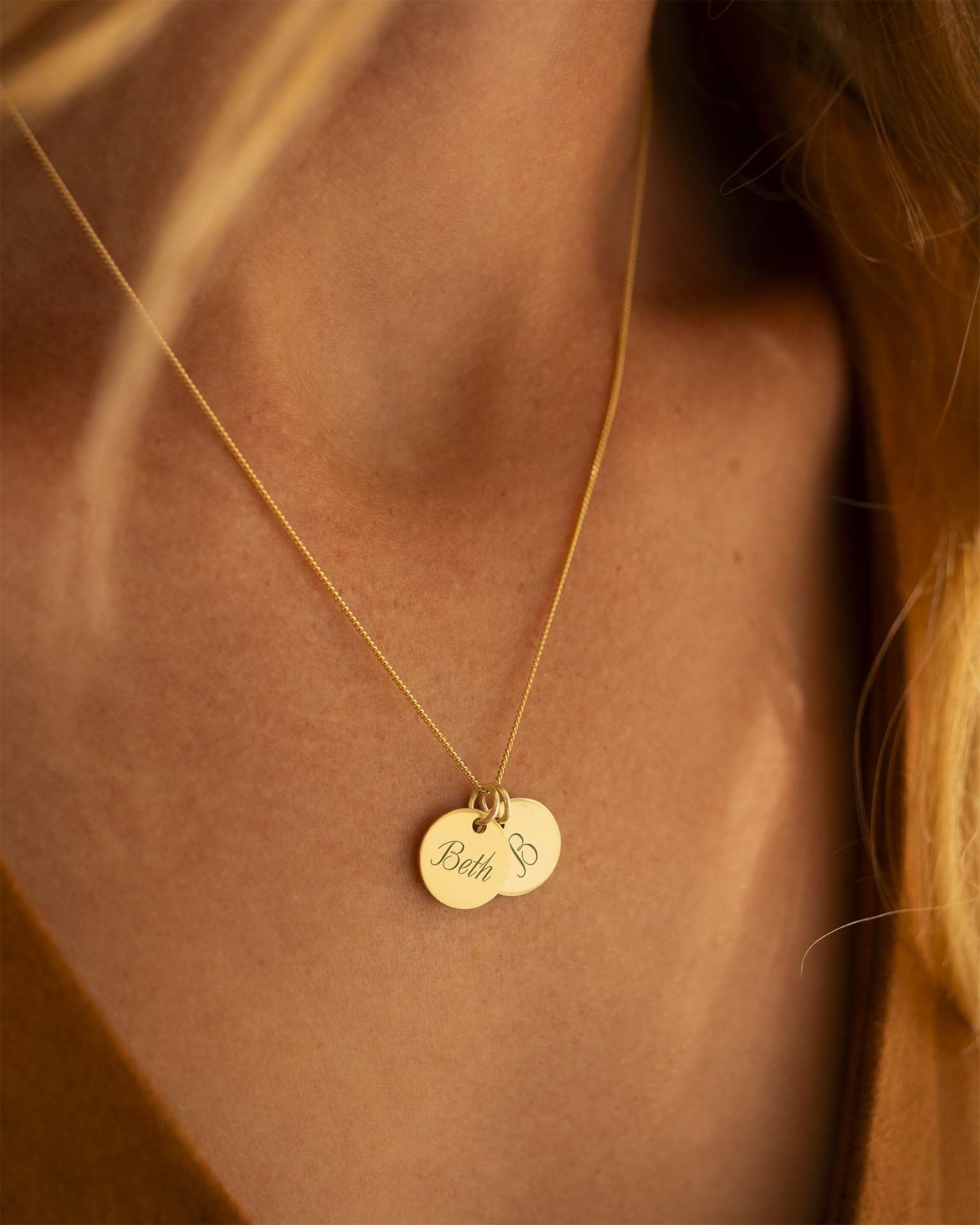 Gold necklace with a pendant on a person's neck | Christmas