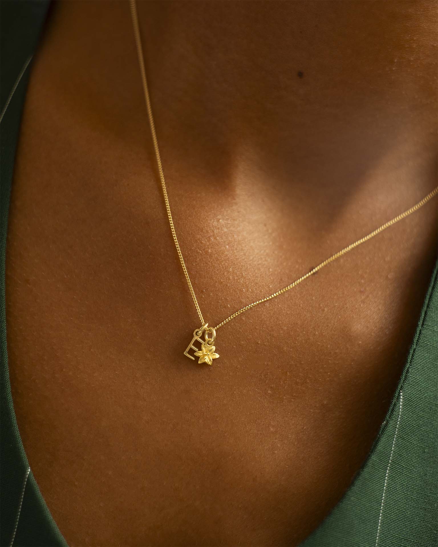 Gold necklace with a star pendant on a person's neck. | Christmas