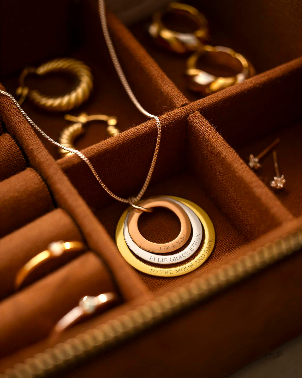 Gold necklace with interlocking rings in a jewelry box
