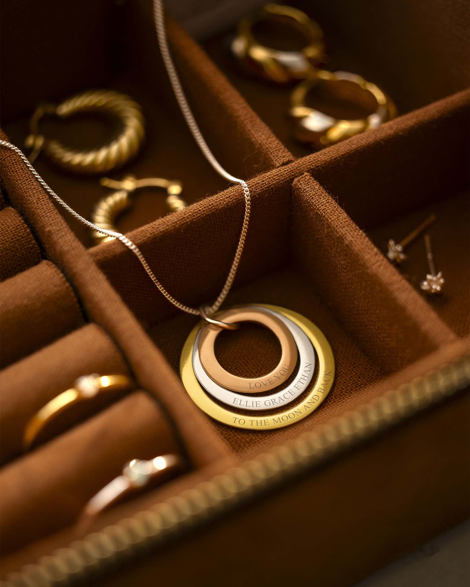 Gold necklace with interlocking rings in a jewelry box
