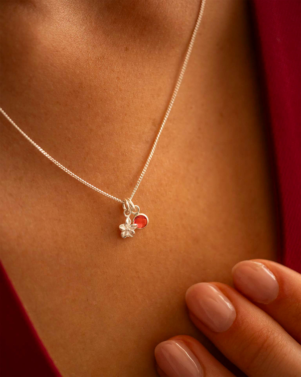 Silver necklace with a heart-shaped pendant worn by a person | Christmas