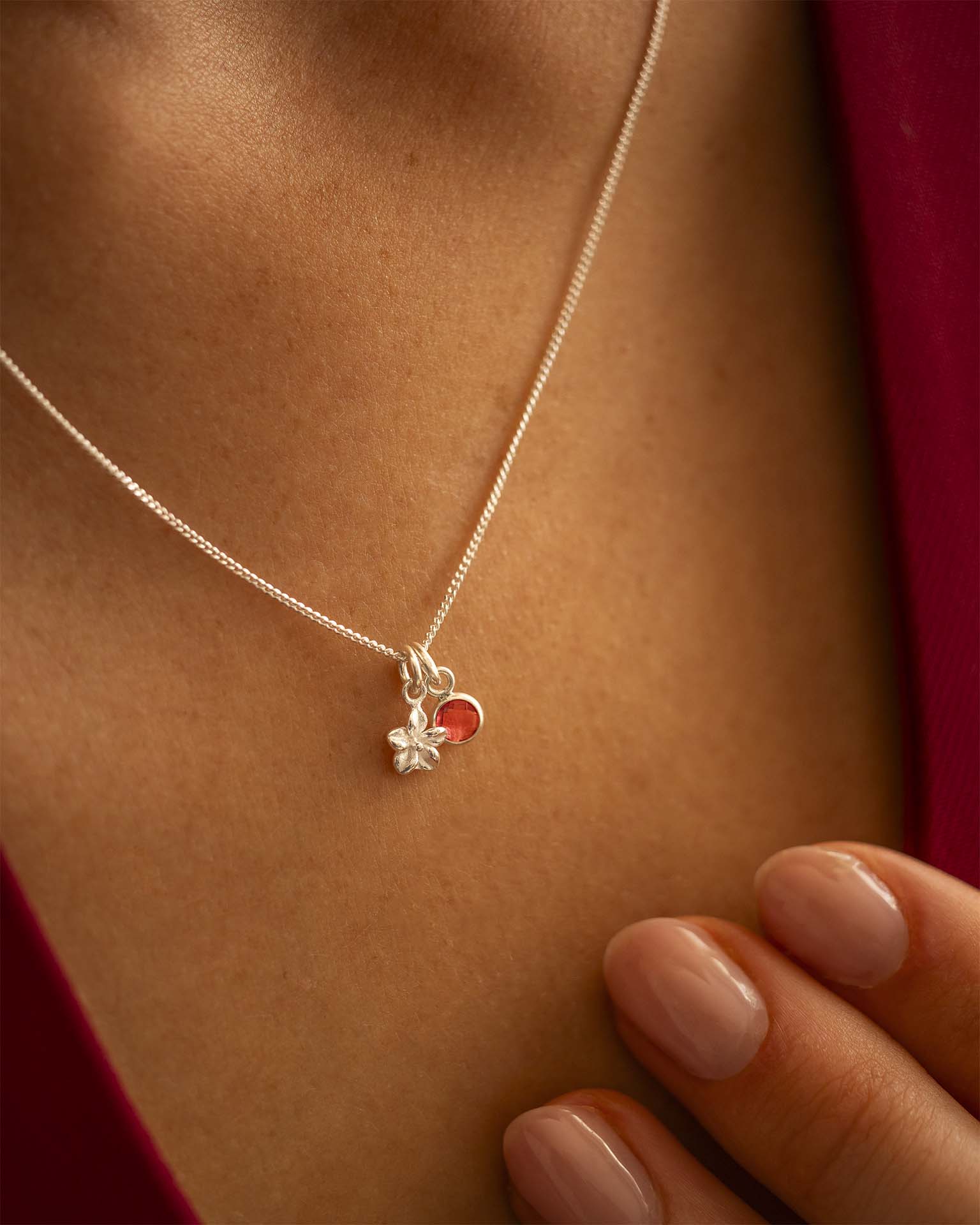 Silver necklace with a heart-shaped pendant worn by a person | Christmas