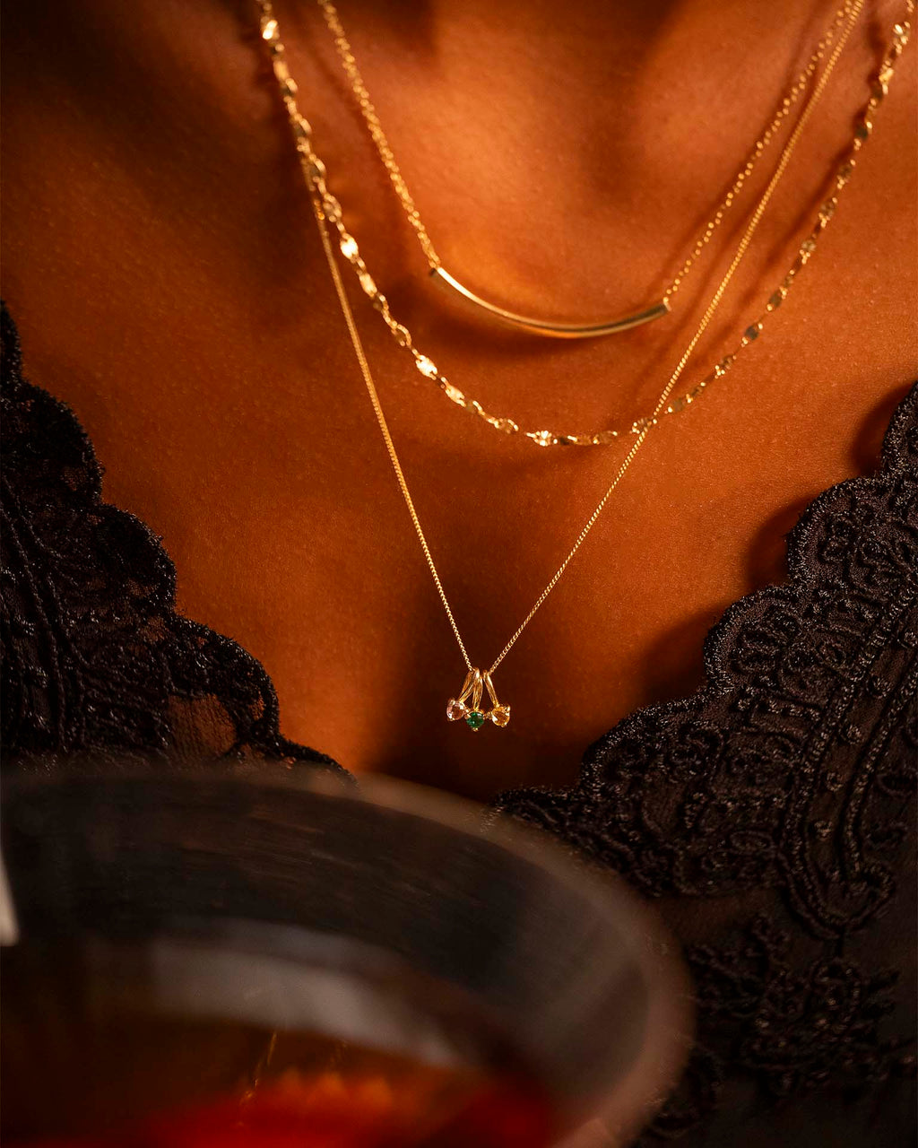 Close-up of a person wearing gold necklaces with a blurred background