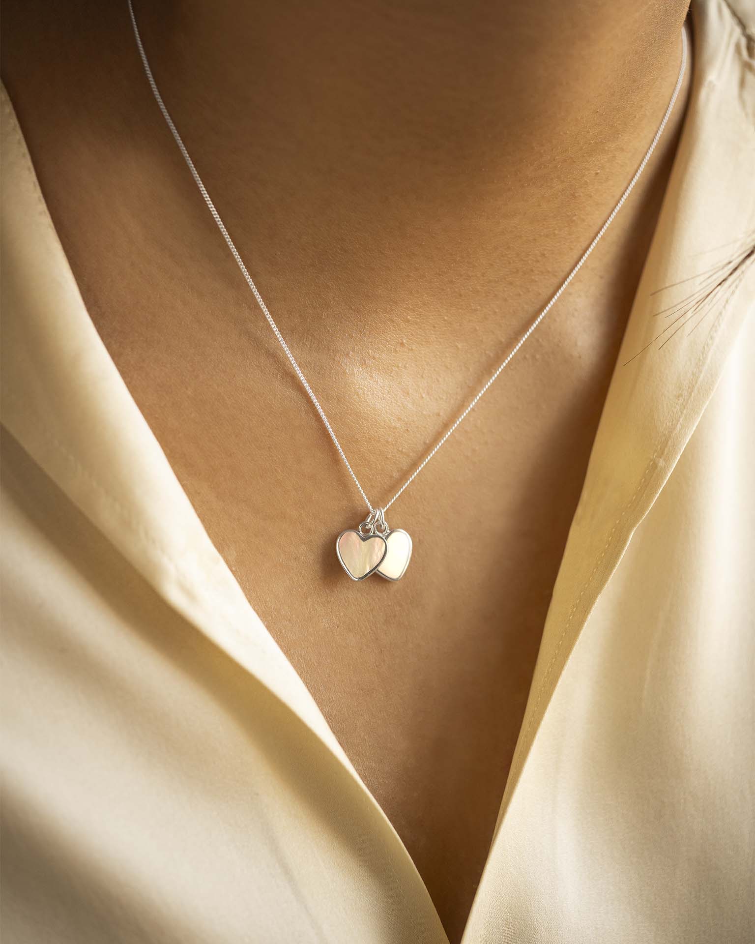 Necklace with heart-shaped pendants on a beige background