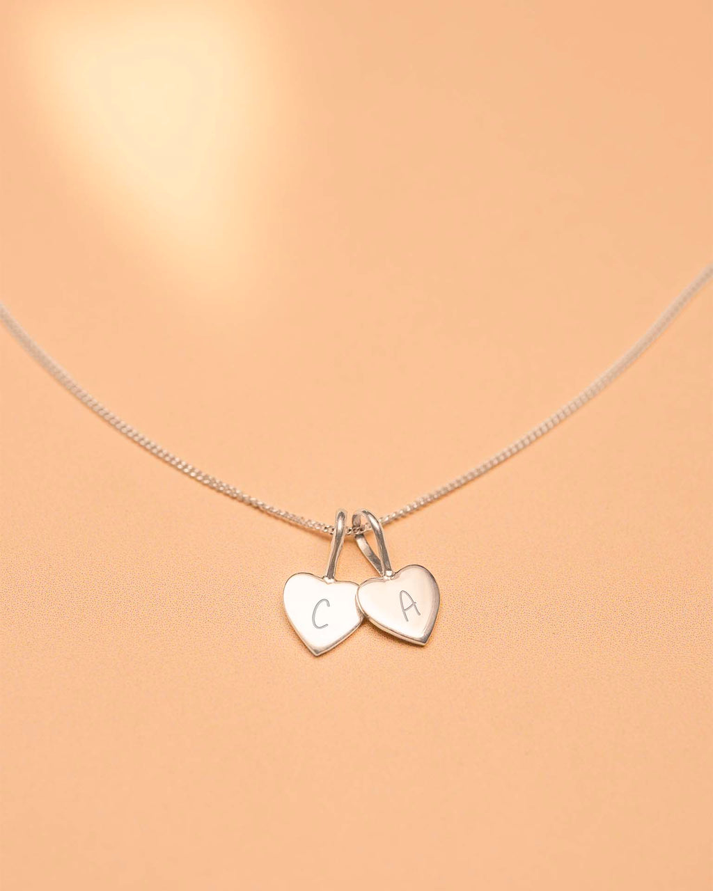 Necklace with heart-shaped charms on a beige background