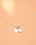 Necklace with heart-shaped charms on a beige background