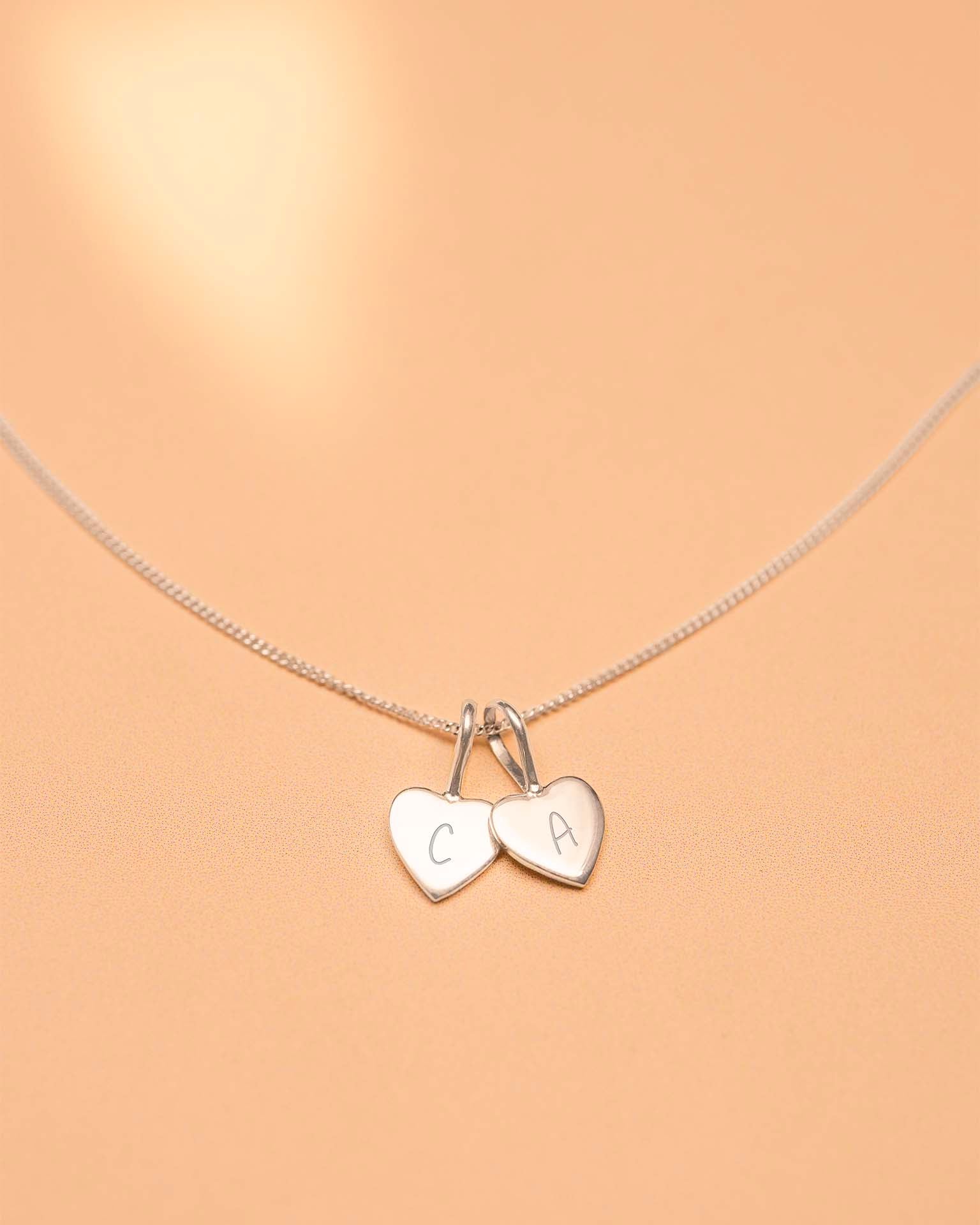 Necklace with heart-shaped charms on a beige background