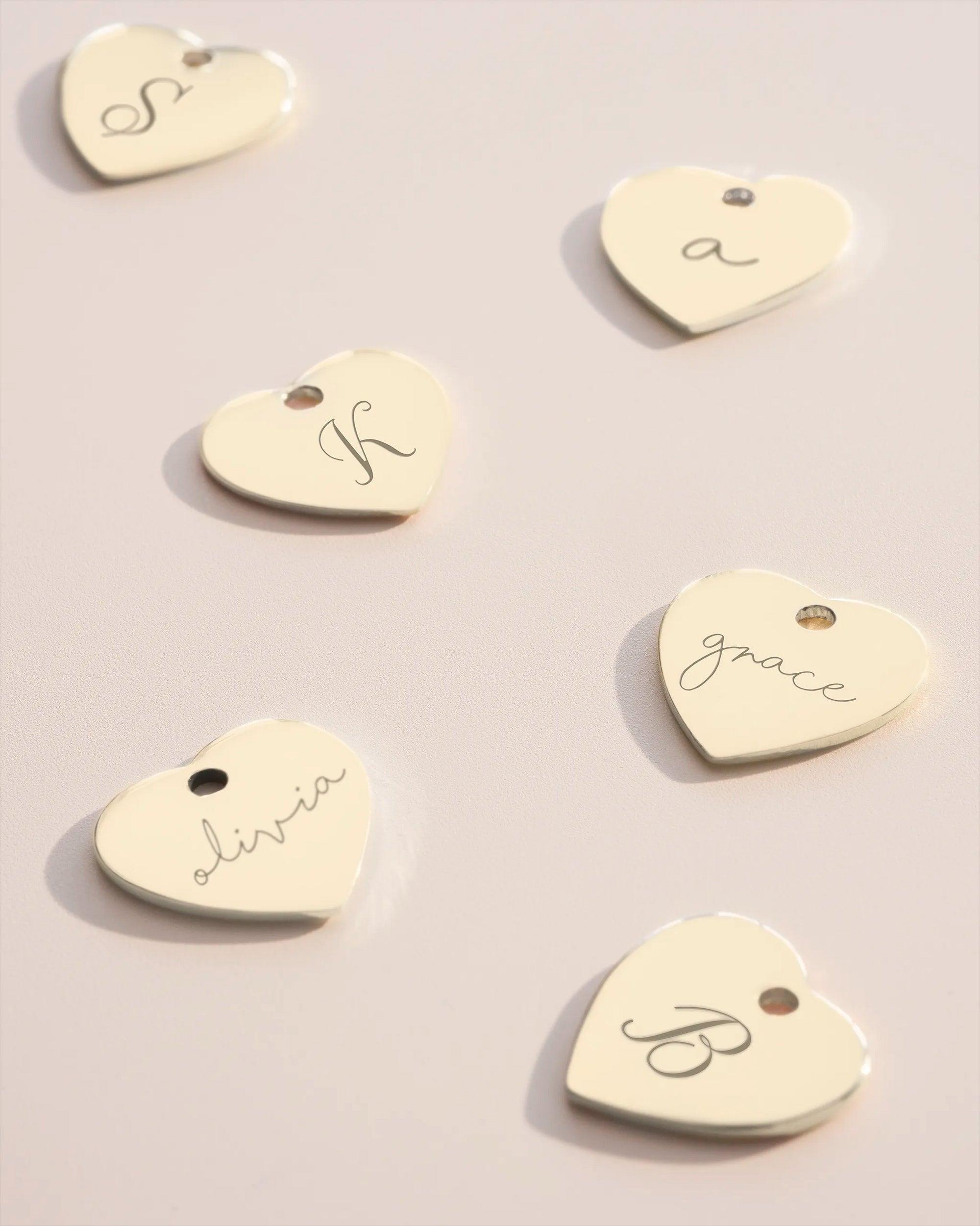 Silver heart charms with initial and name engravings