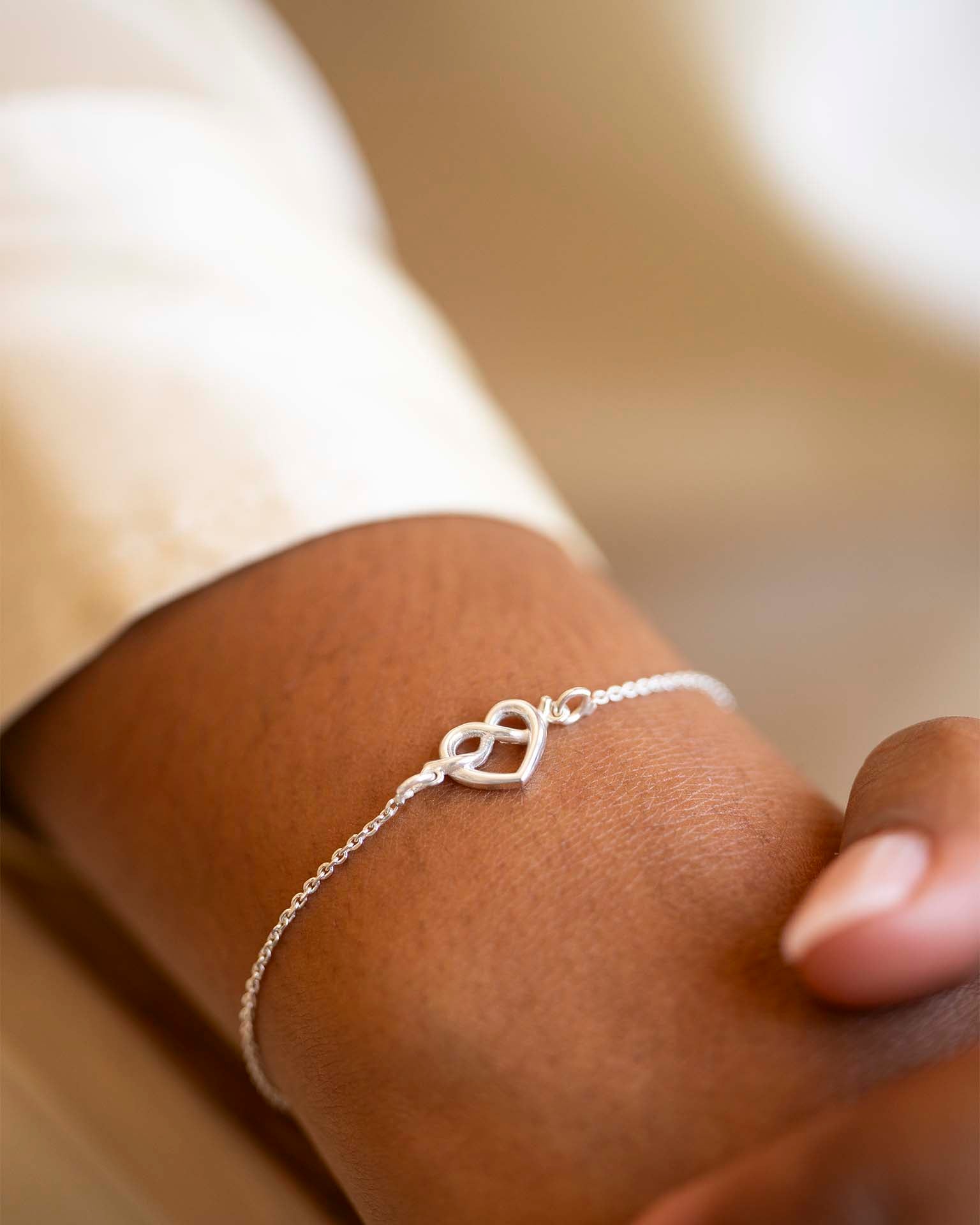 Silver bracelet on a wrist with a blurred background