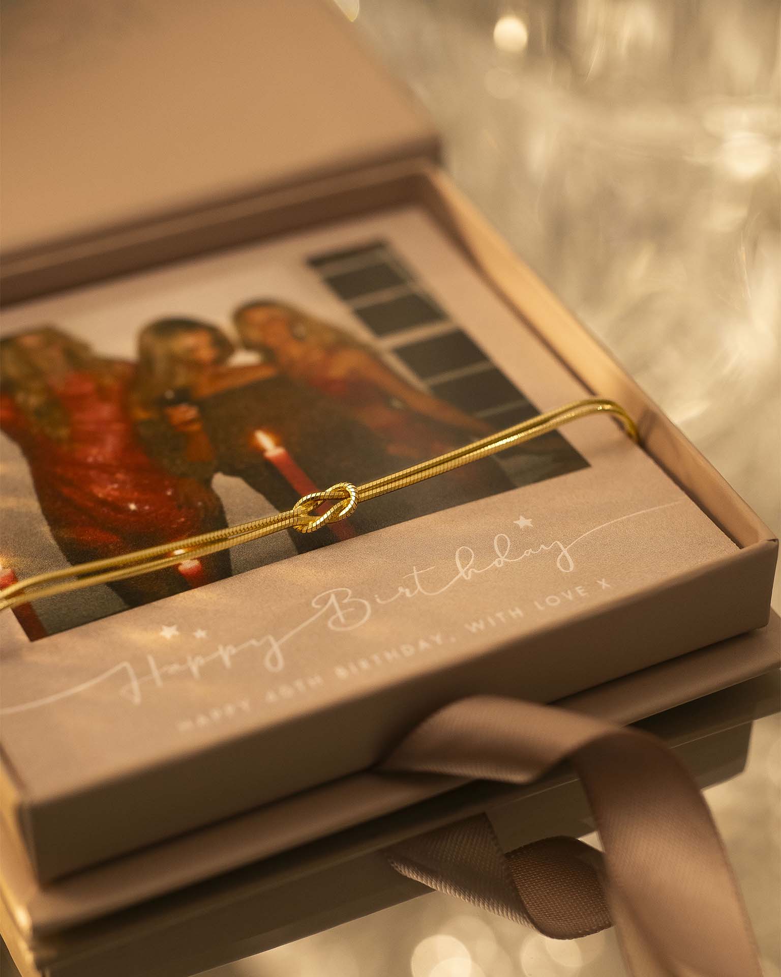 Gold bracelet in a gift box with a birthday card inside