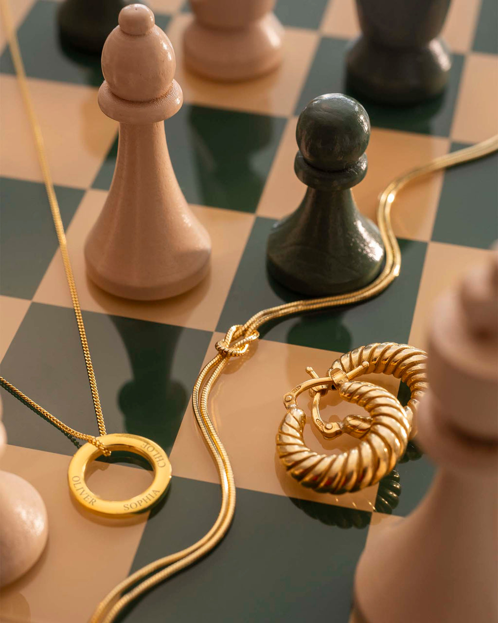 Gold jewelry on a chessboard with chess pieces