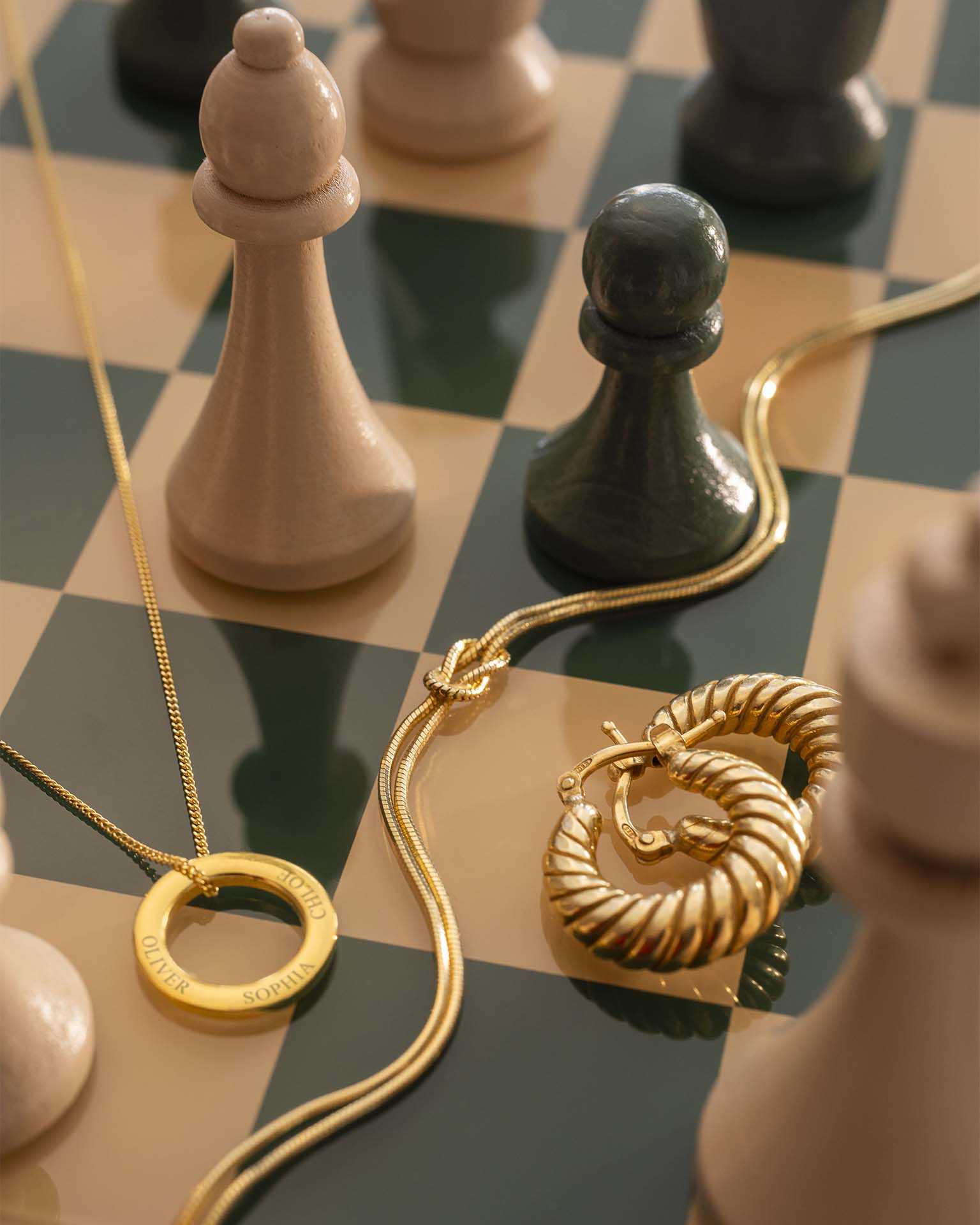 Gold jewelry on a chessboard with chess pieces