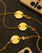 gold initial disc bracelet on navy background | Christmas