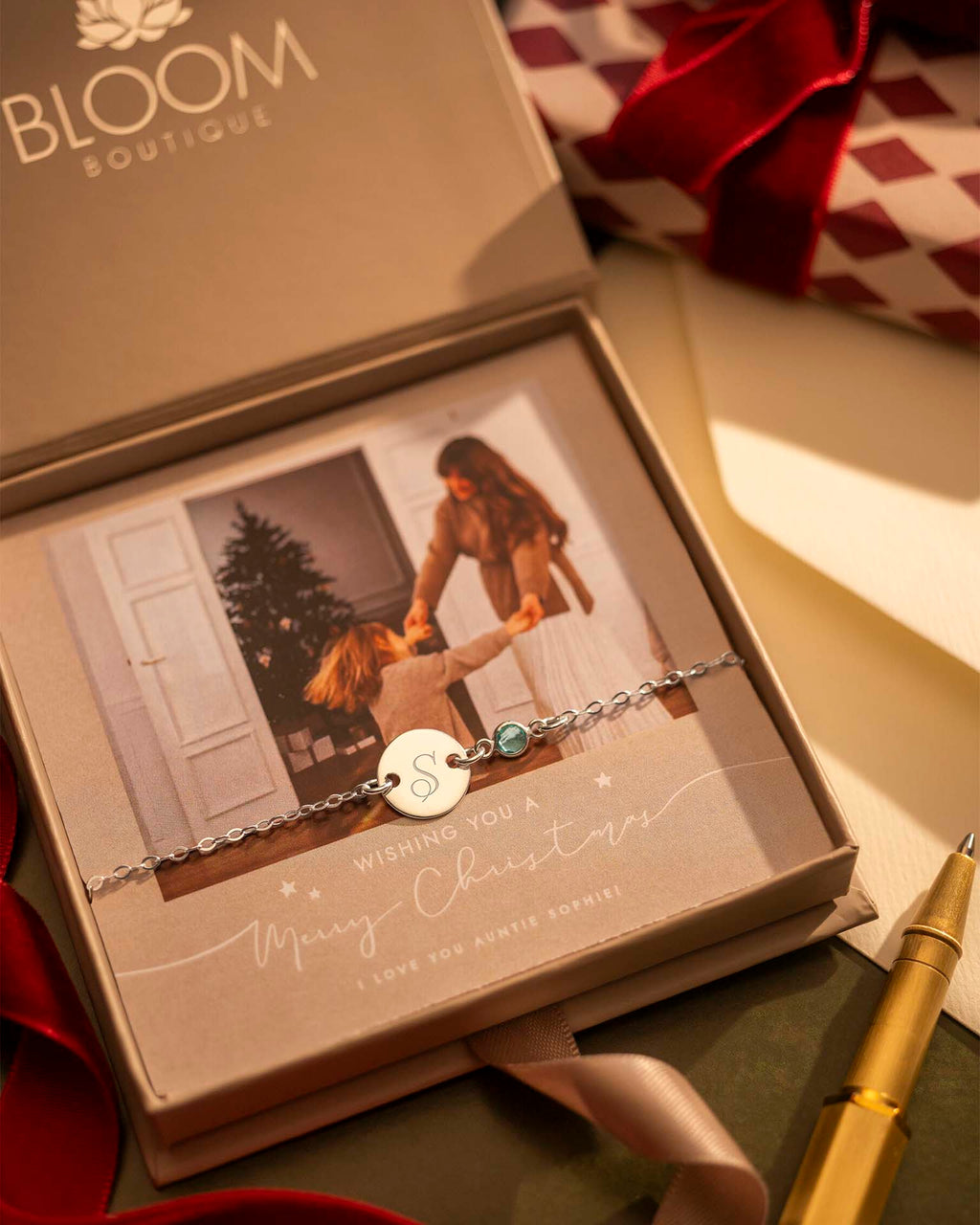 Bracelet with a heart charm in a Bloom Boutique box with a photo of two people.