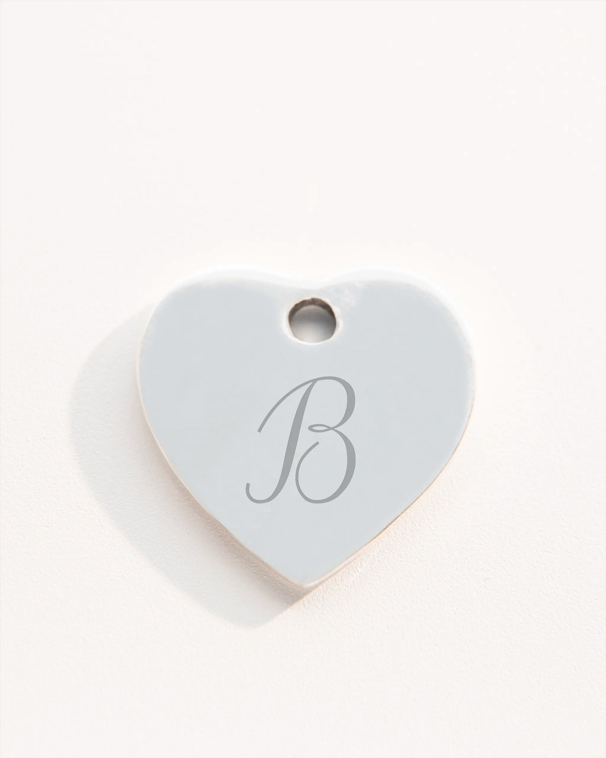 Silver heart charm with initial engraving