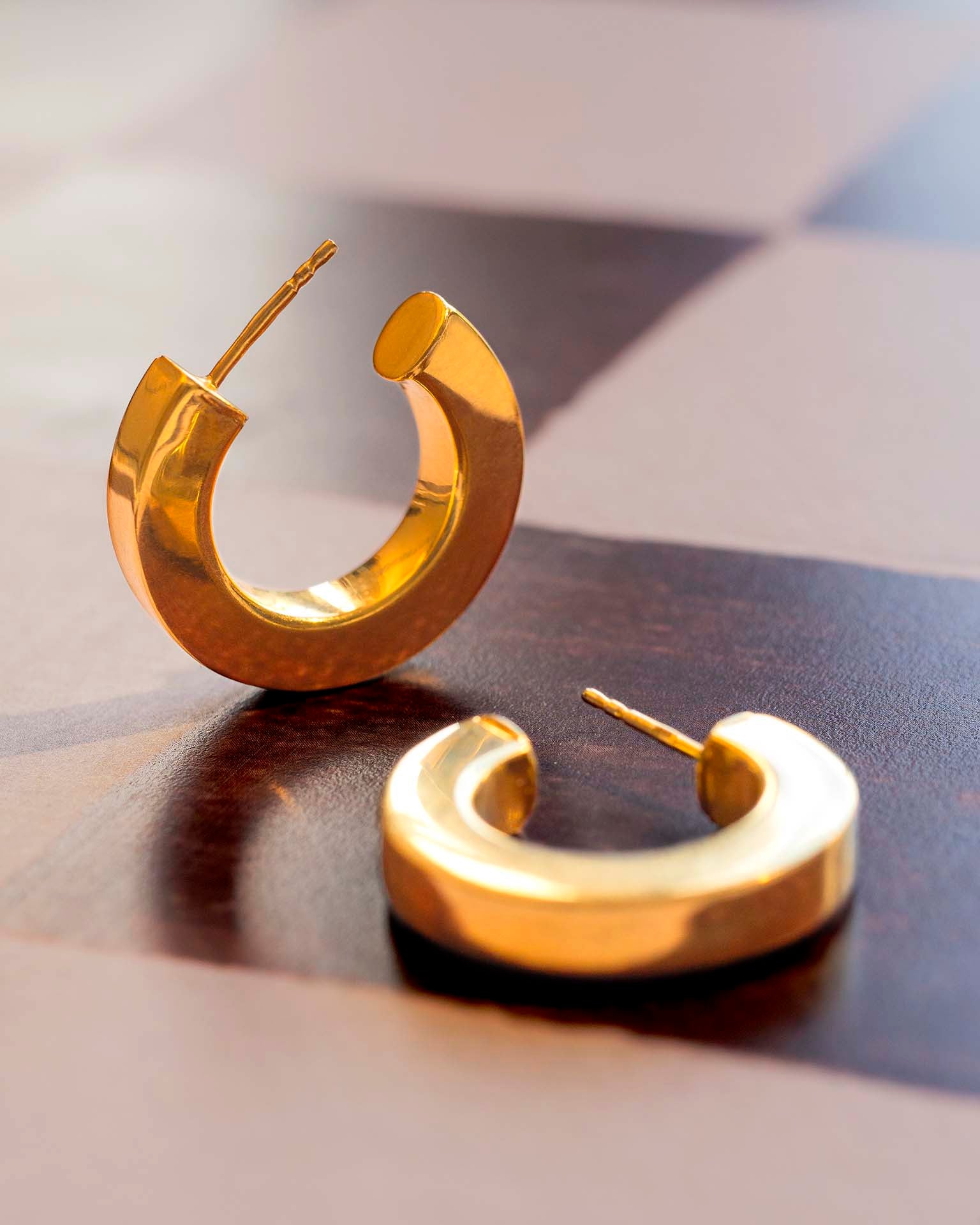 Gold earrings on check background | Christmas