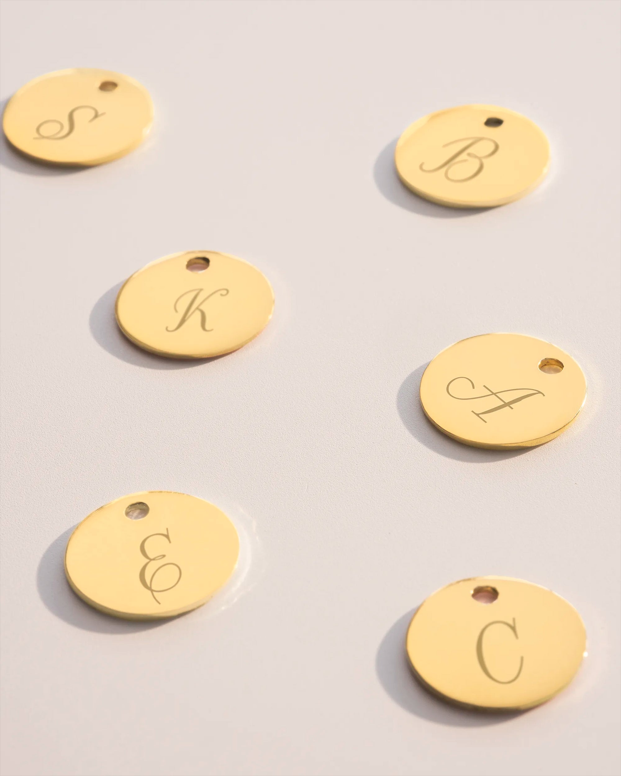 Gold disc charms with initial engravings