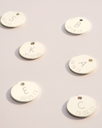 Silver disc charms with initial and date engravings