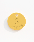 Gold disc charm with initial and date