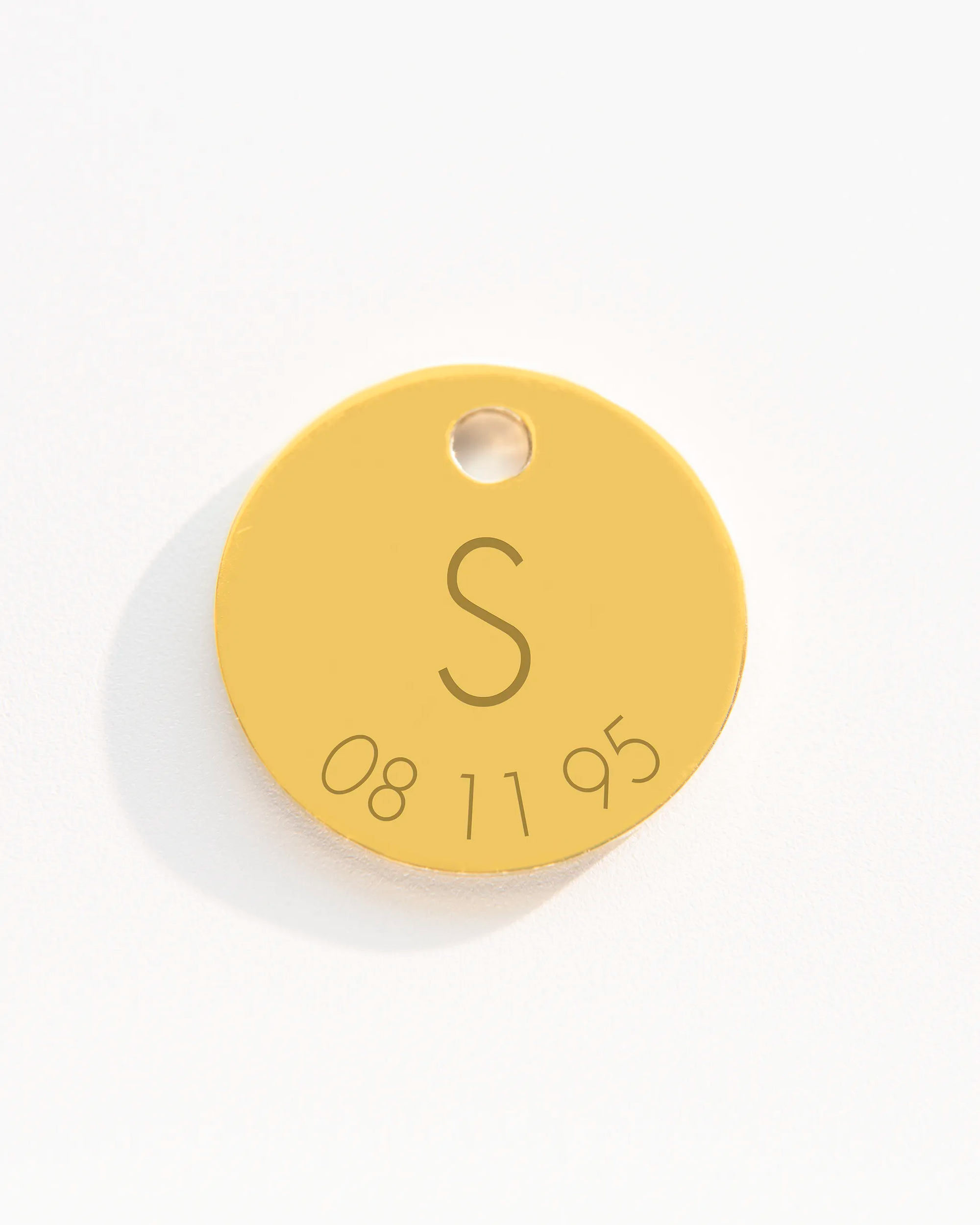 Gold disc charm with initial and date