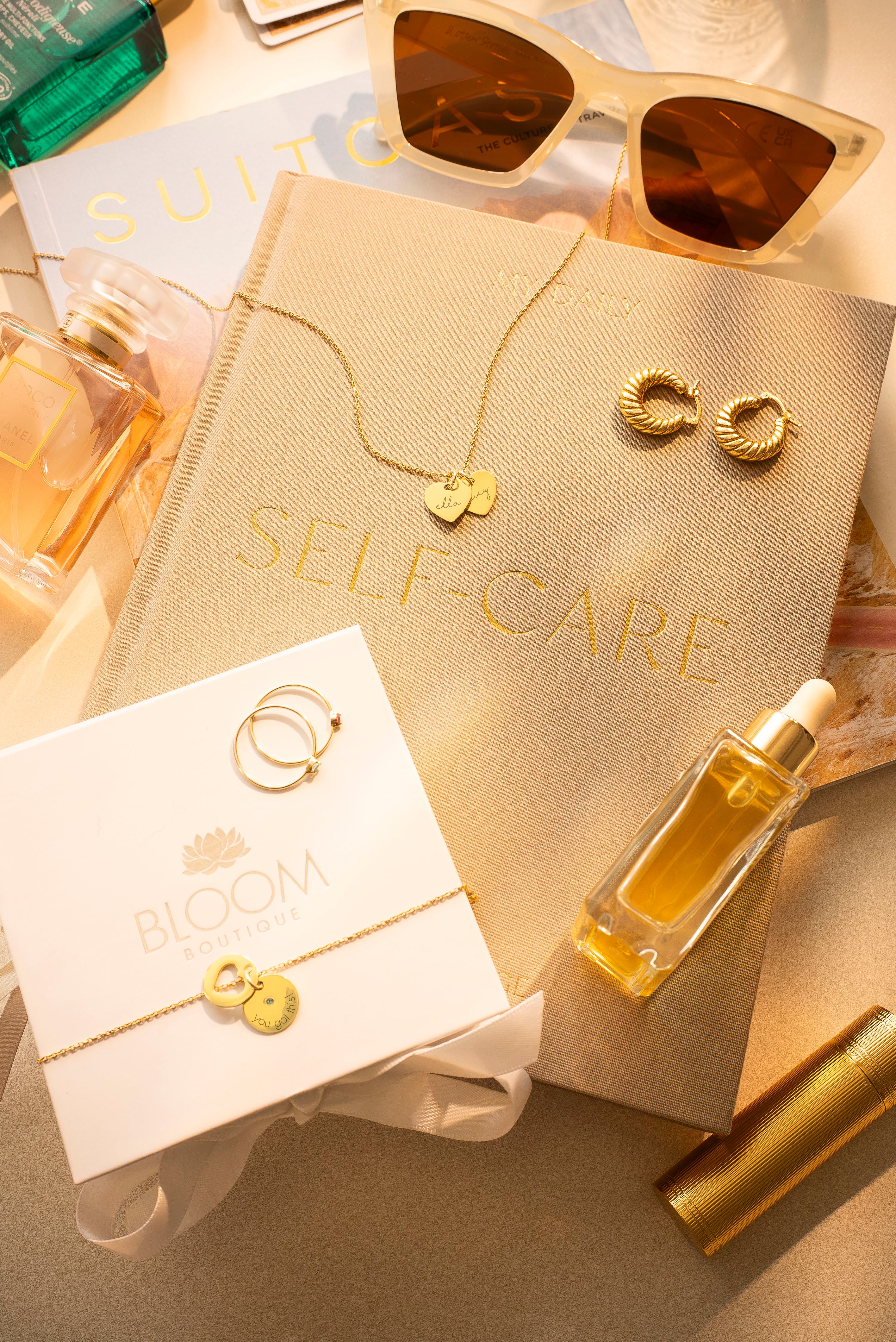 Gold jewelry and self-care items on a light surface