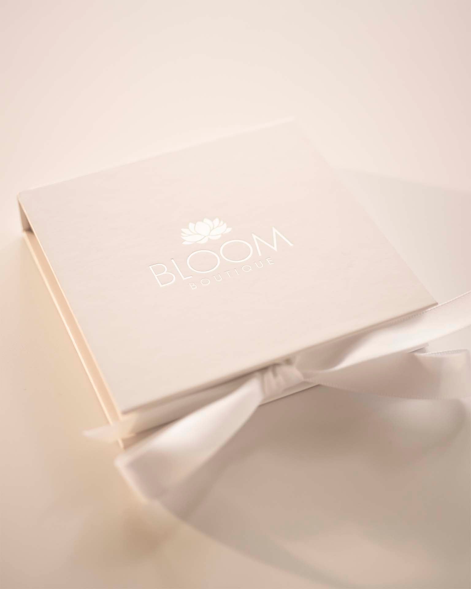 Product packaging with 'BLOOM' branding on a light background