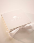 Product packaging with 'BLOOM' branding on a light background