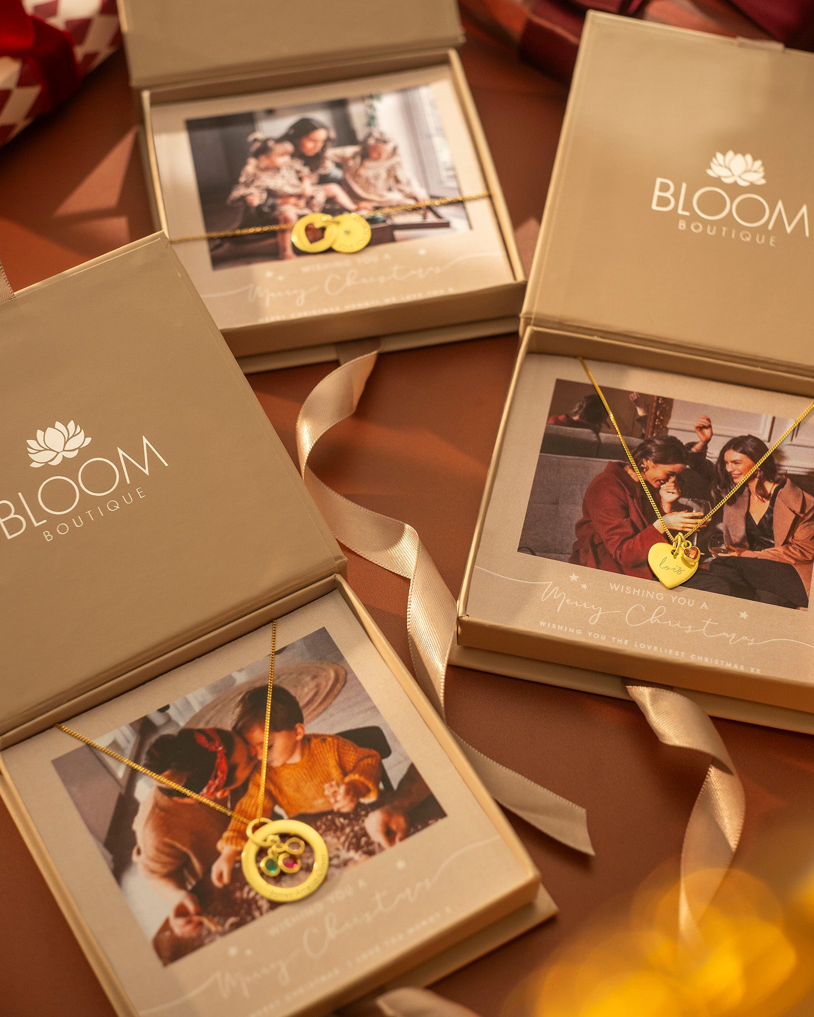 Bloom Boutique jewelry boxes with heart-shaped necklaces on a wooden surface