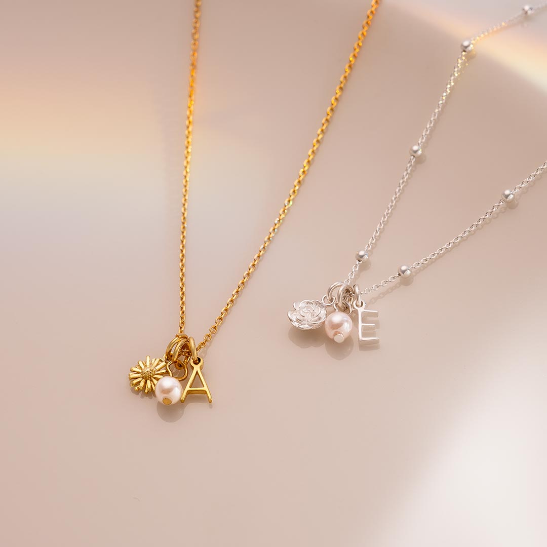 gold plated sterling silver and sterling silver birth flower, mini letter and pearl personalised necklaces