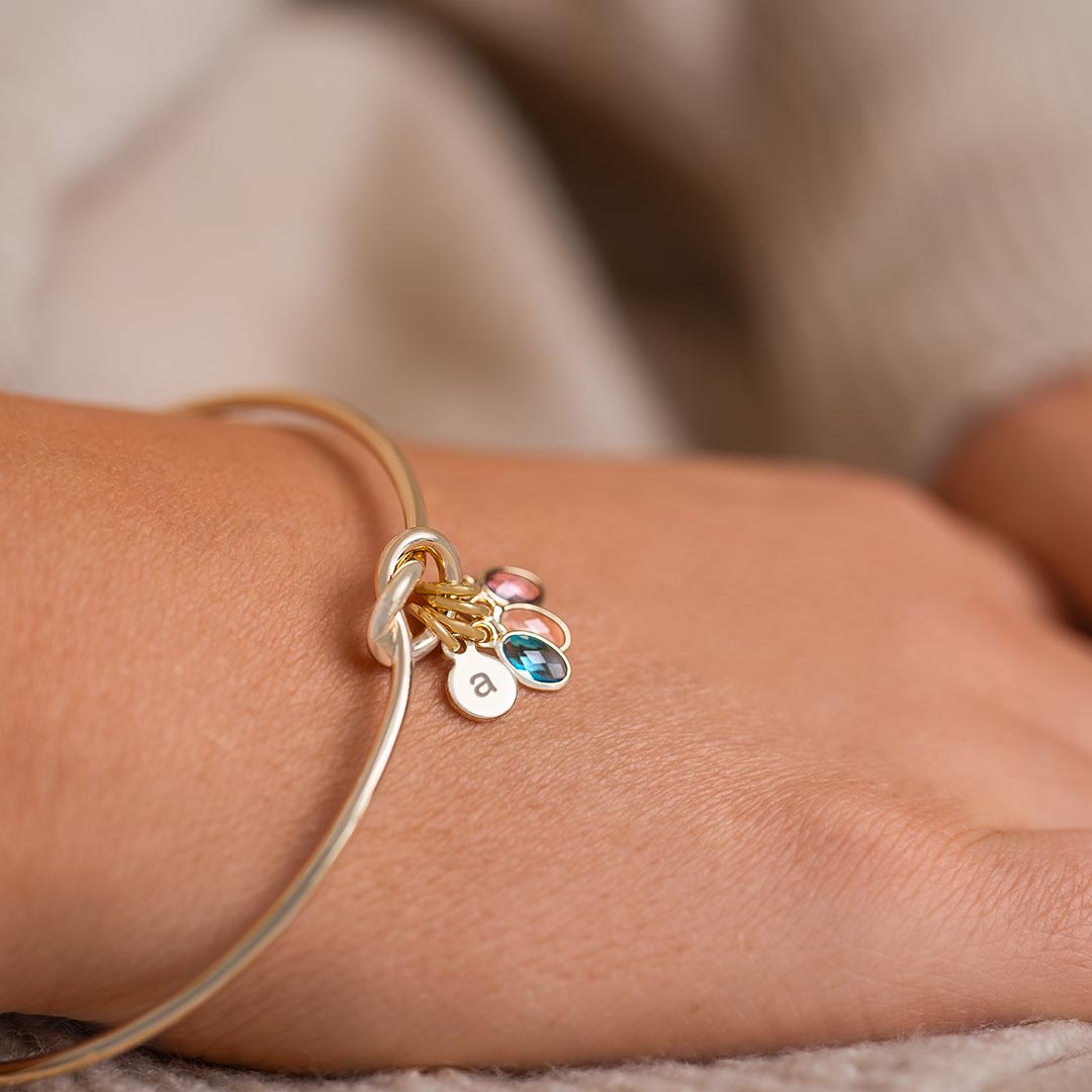 champagne gold plated knot bangle with family birthstone charms