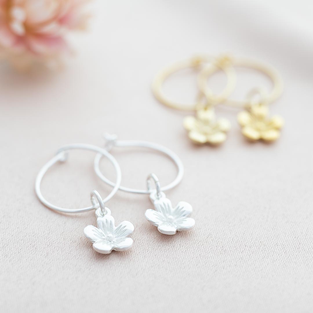 flower charm hoop earrings available in sterling silver and gold plated sterling silver